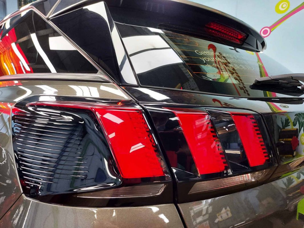 The coated bonnet of the Peugeot 3008 under workshop lighting.