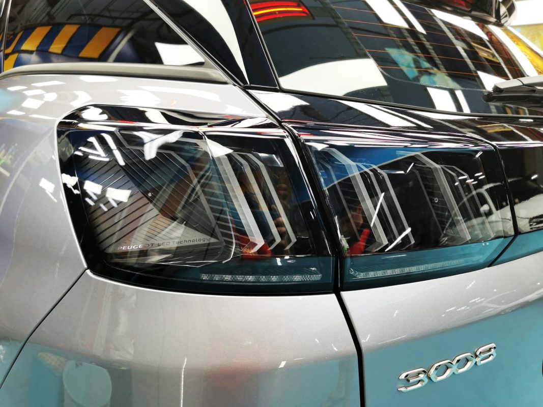 The coated bonnet of the Peugeot 3008 under workshop lighting.