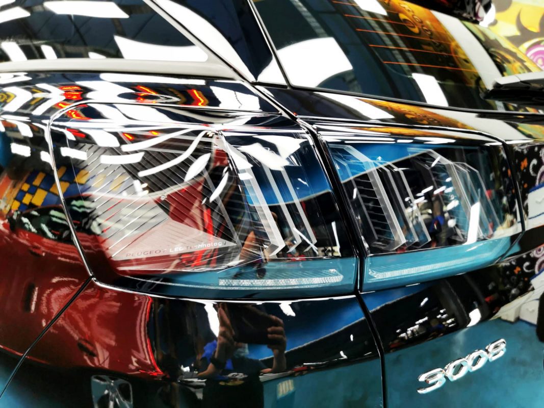 The coated bonnet of the Peugeot 3008 under workshop lighting.