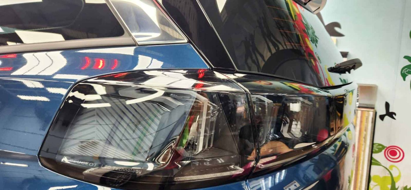 The coated bonnet of the Peugeot 5008 under workshop lighting.