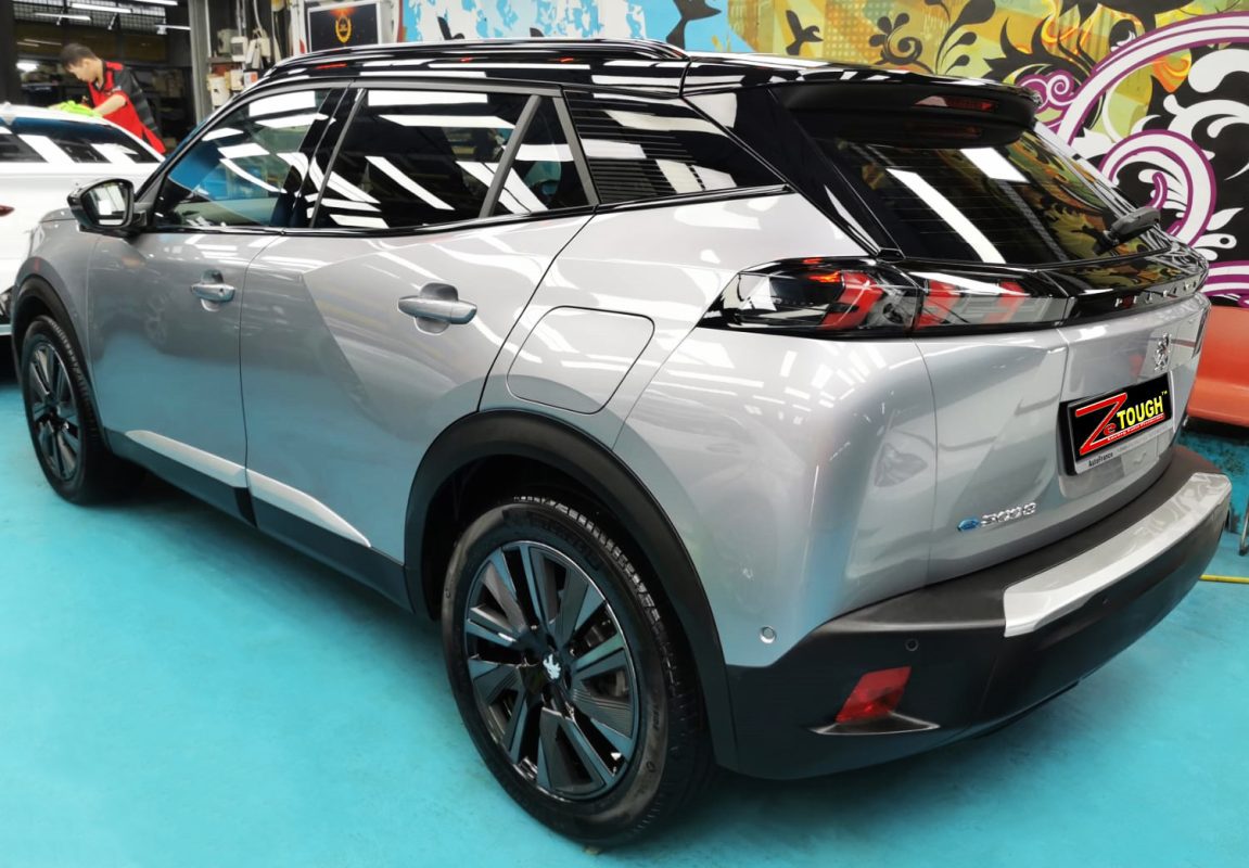 Rear quarter of the Peugeot e-2008 GT, glossy and protected.