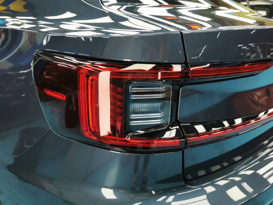 The coated bonnet of the Polestar 2 under workshop lighting.