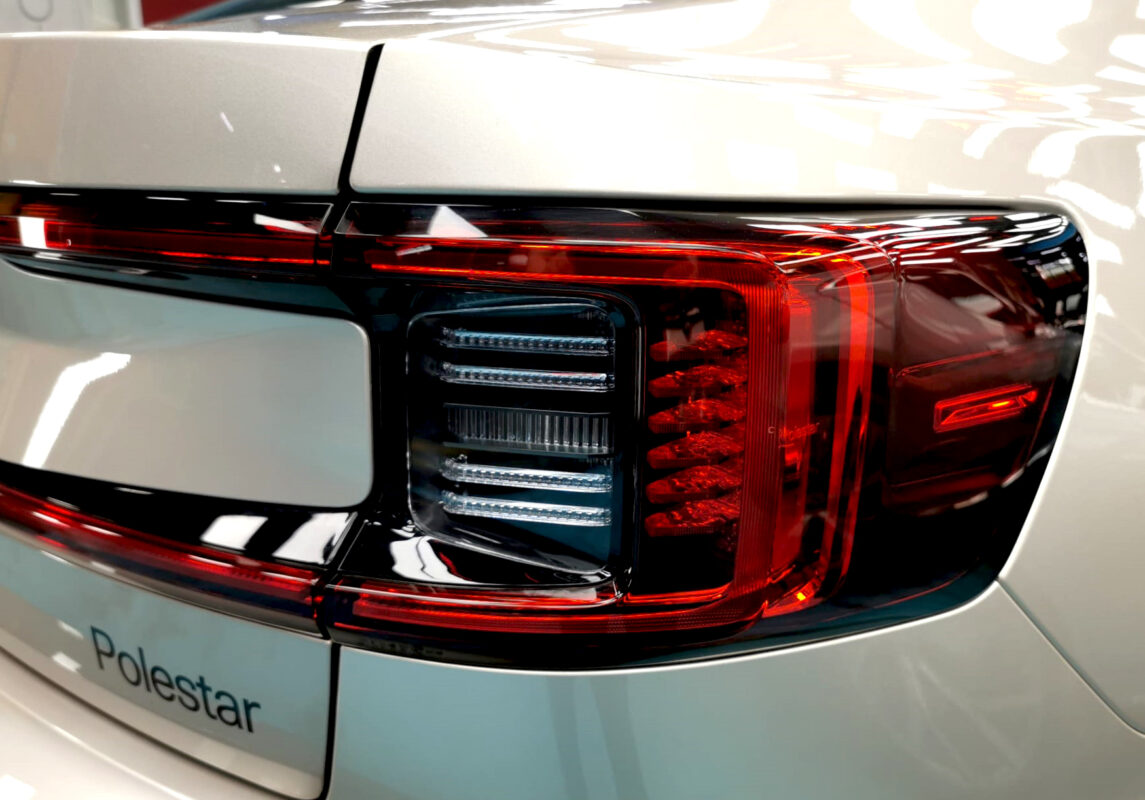 Close-up of the Polestar 2's coated surface under workshop lighting.