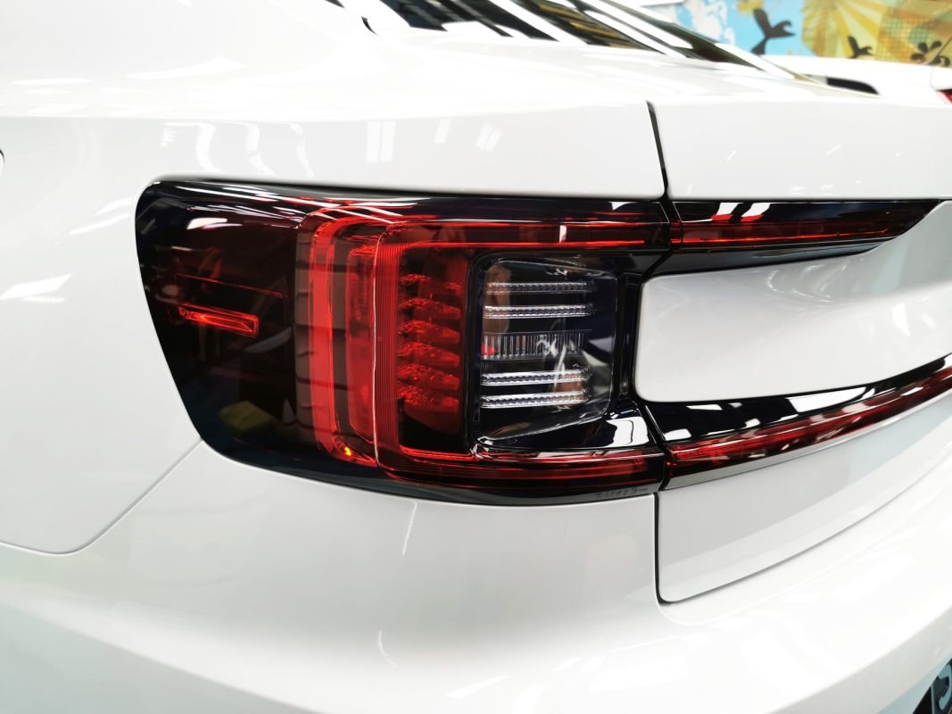 The coated bonnet of the Polestar 2 under workshop lighting.