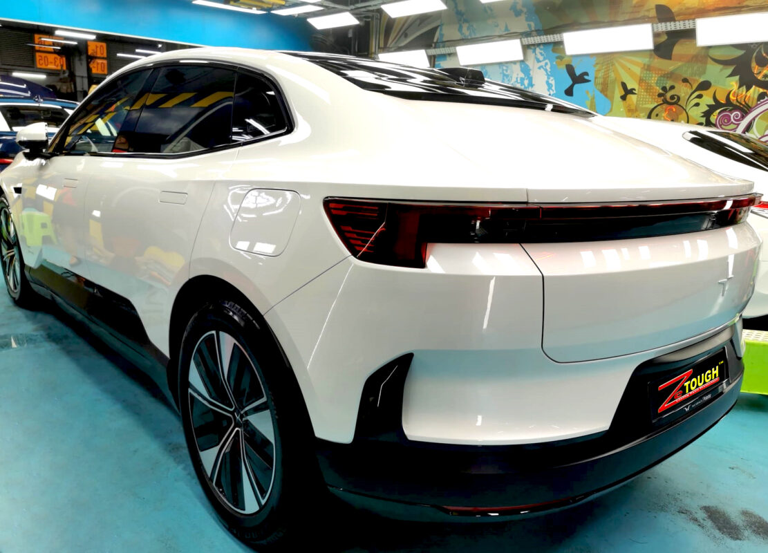 Rear quarter of the Polestar 4, glossy and protected.