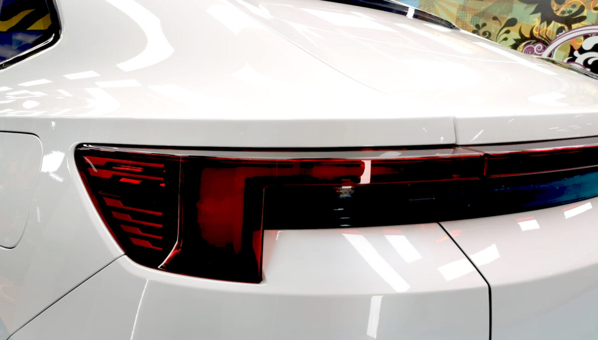 The coated bonnet of the Polestar 4 under workshop lighting.