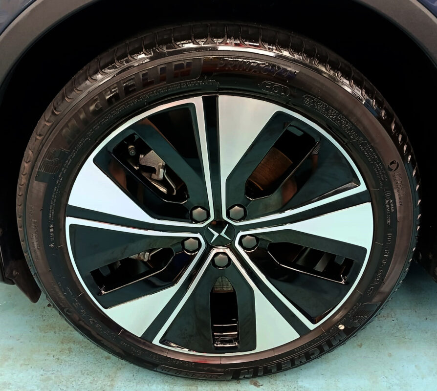 Close-up of the Polestar's coated surface under workshop lighting.