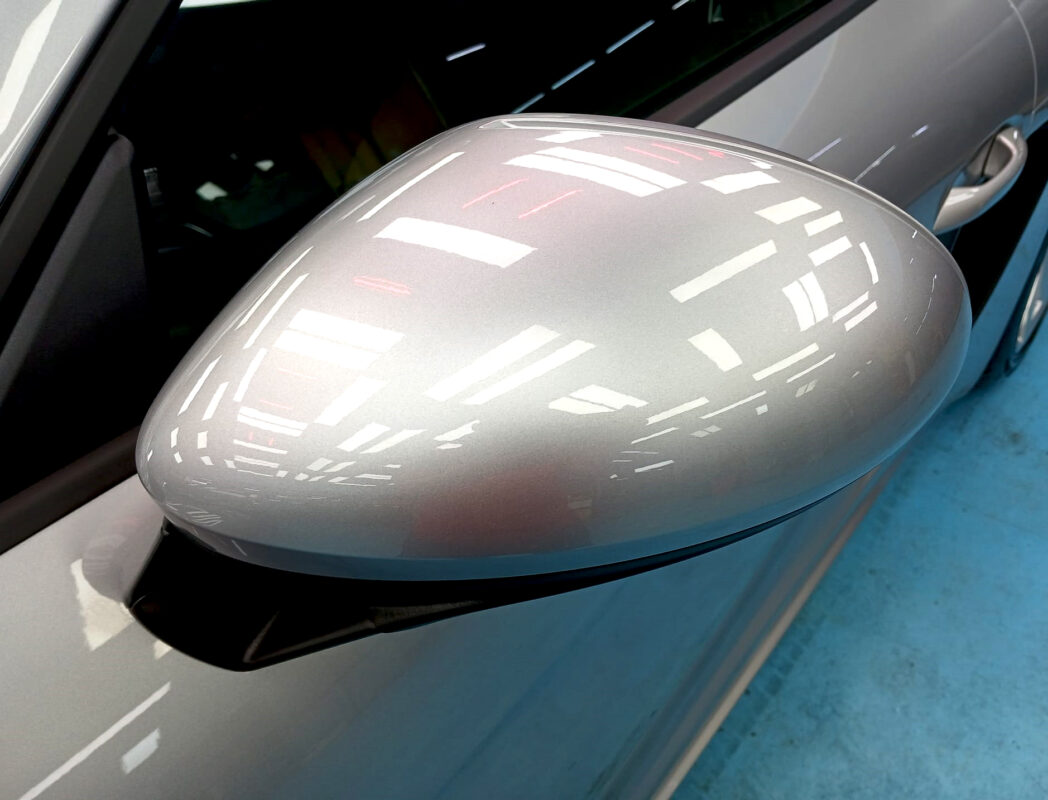 Rear quarter of the Porsche 718 Boxster, glossy and protected.