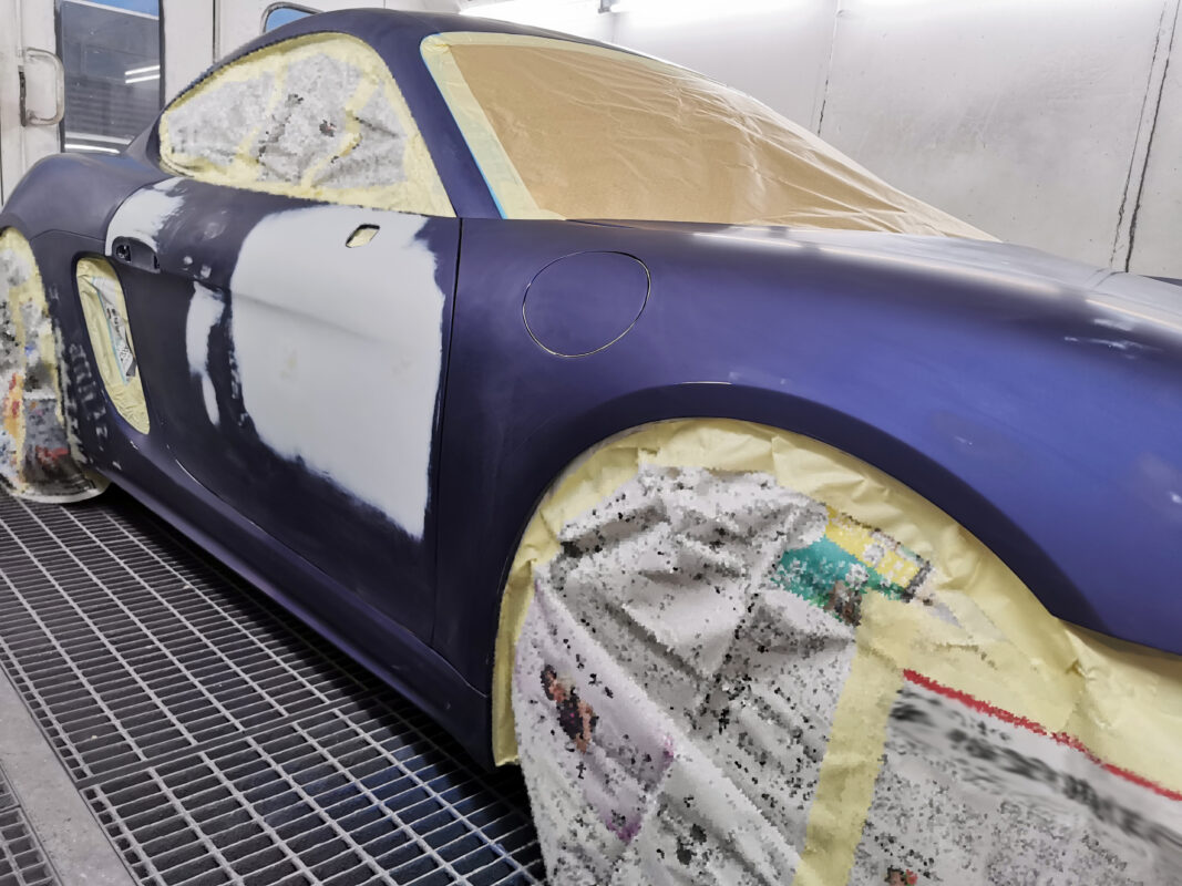 The 718 Cayman masked up, all non-painted surfaces protected before spraying.