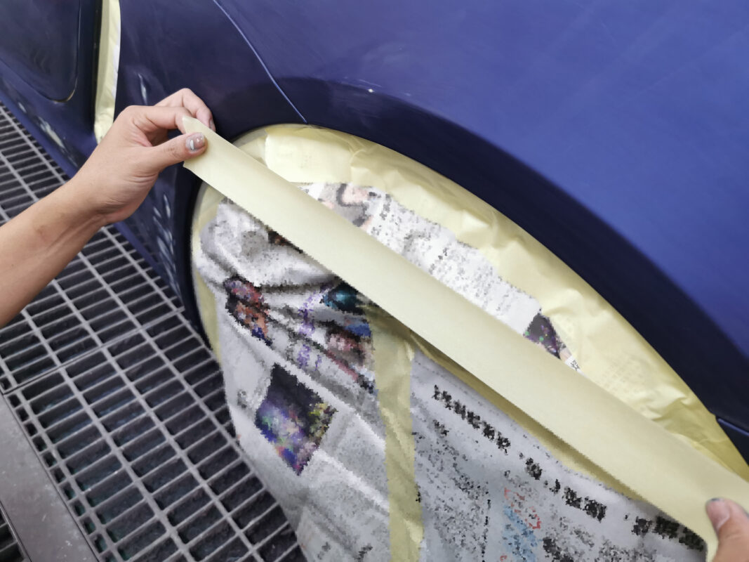 The Porsche 718 Cayman in the spray booth receiving its fresh coat of paint.
