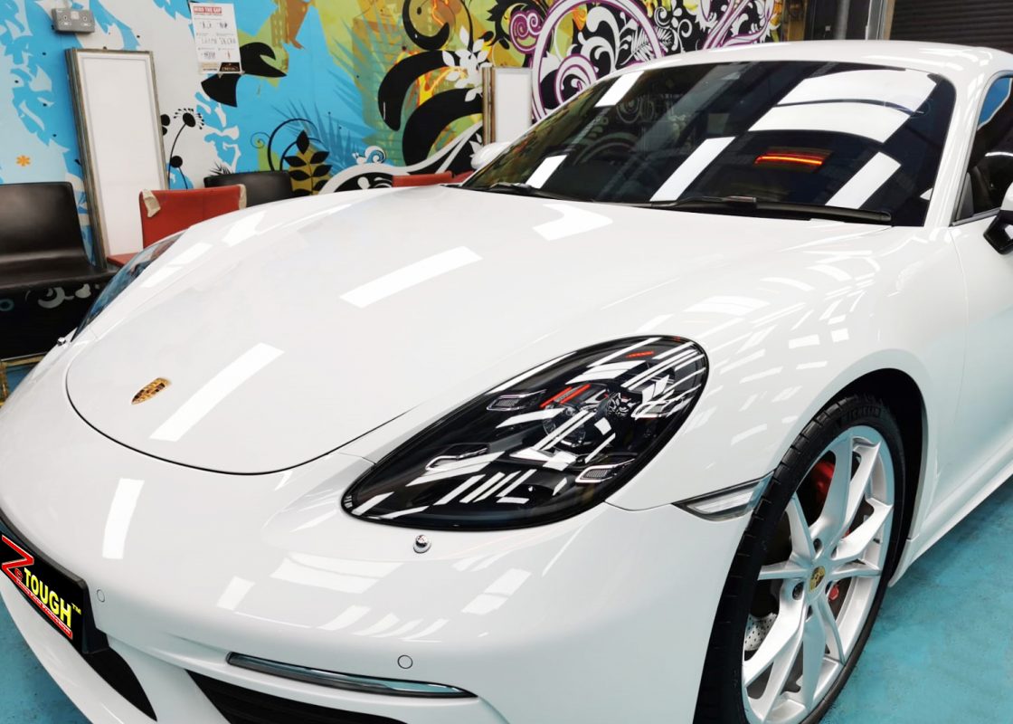 The Porsche 718 Cayman from a side angle after the ceramic coating.