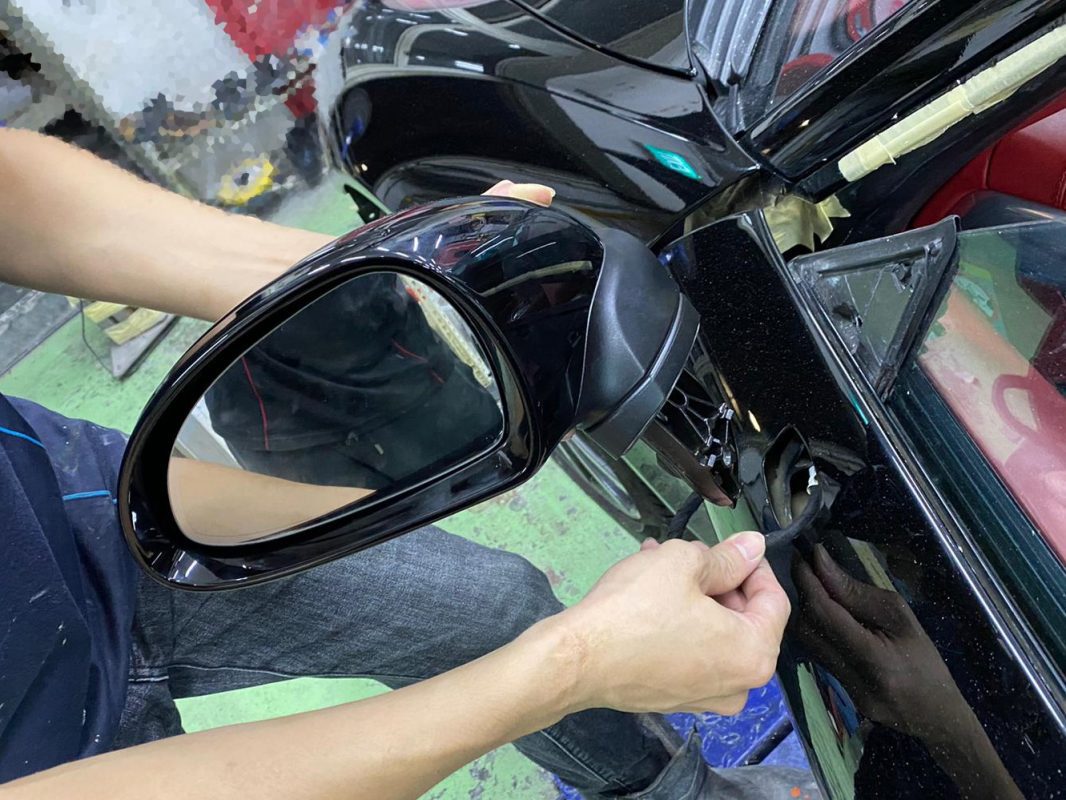 Previously removed car parts being refitted onto the 911 Carrera.