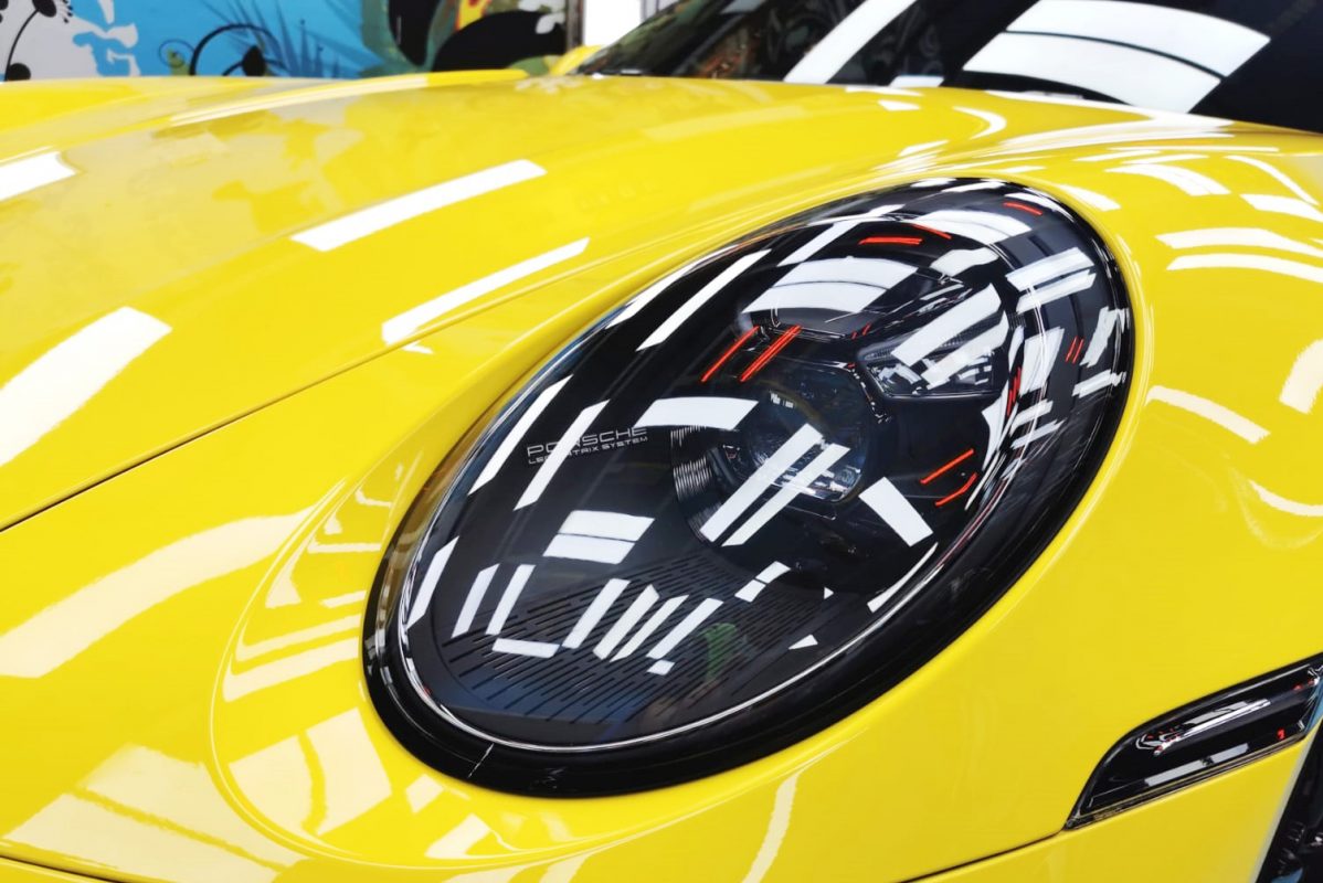 The 911 Carrera S's coated paintwork showing clean reflections.
