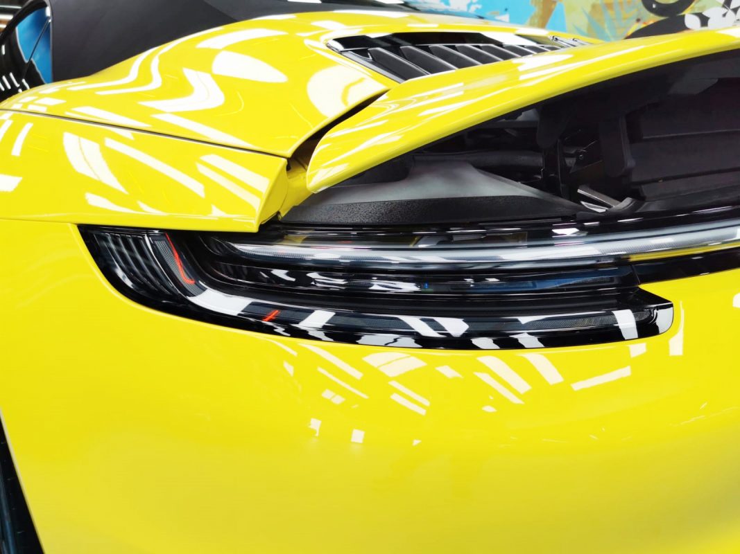 Rear quarter of the 911 Carrera S, glossy and protected.