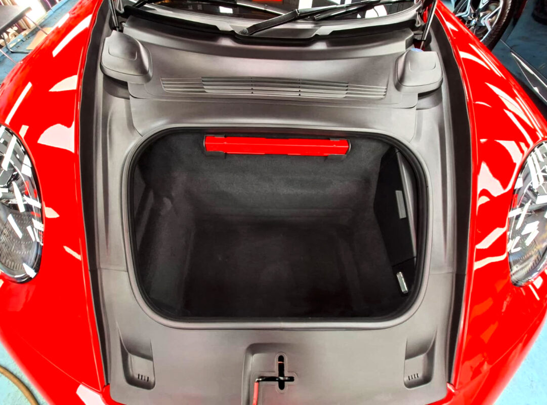 Reflections across the coated panels of the Porsche 911 Carrera.