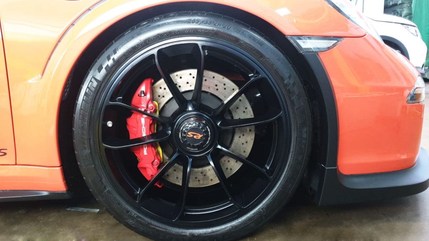 The coated bonnet of the 911 GT3 RS under workshop lighting.