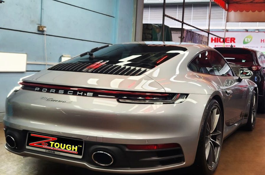 Rear quarter of the 911 Panamera, glossy and protected.