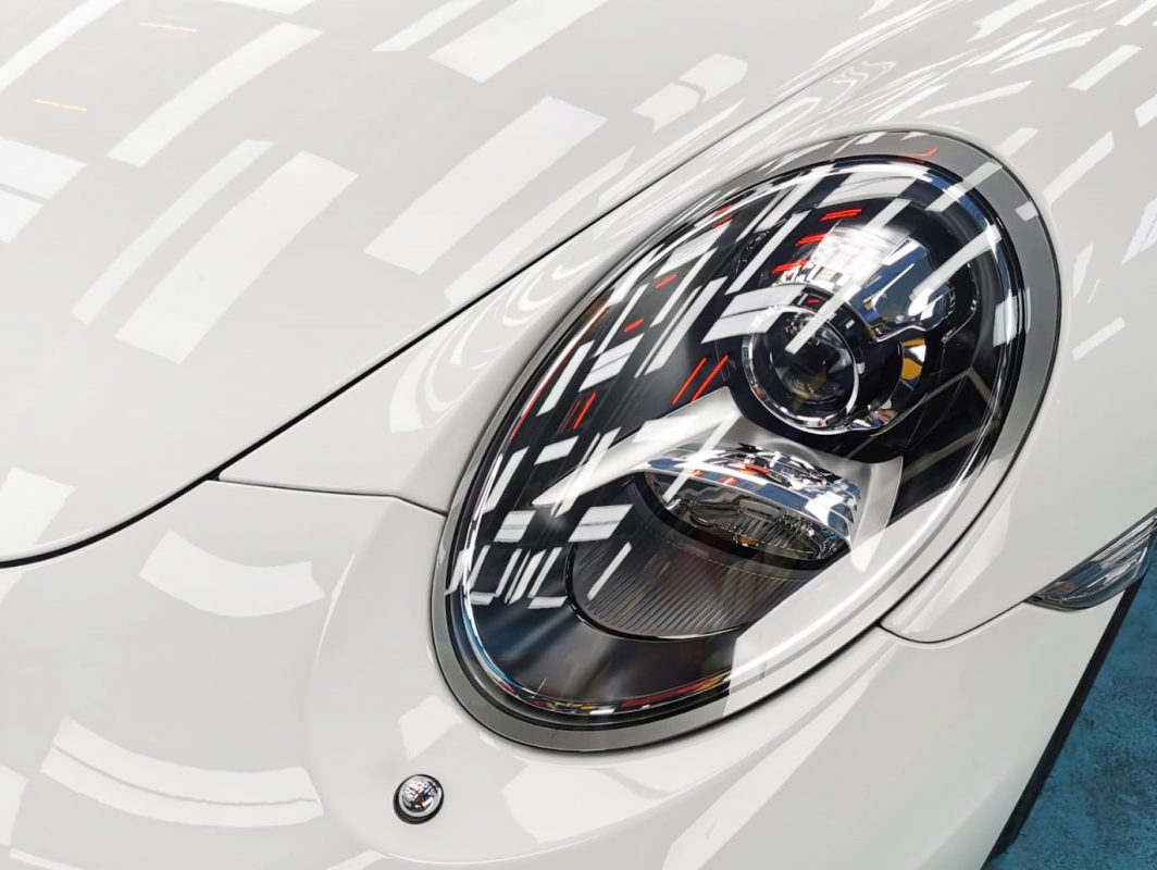 The 911's coated paintwork showing clean reflections.