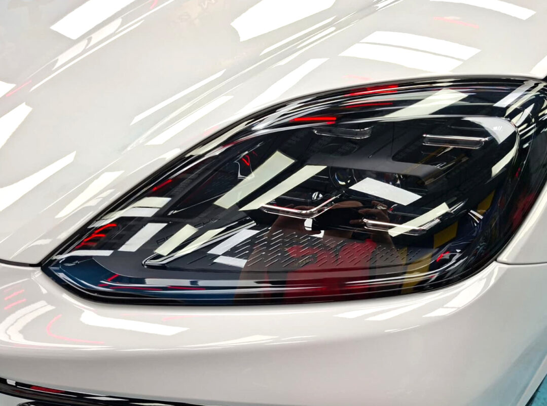 The Porsche Cayenne's coated paintwork showing clean reflections.