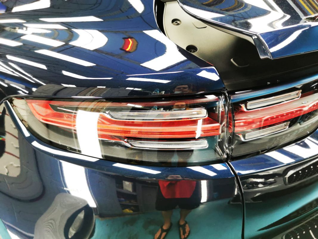 The coated bonnet of the Porsche Cayenne under workshop lighting.