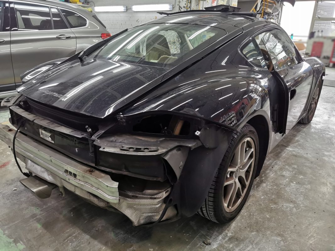 Car parts being dismantled from the Cayman before spraying.