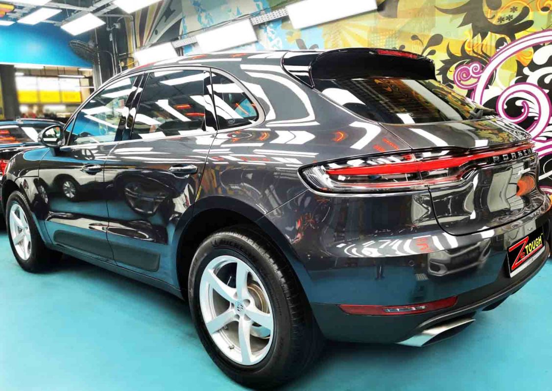 Rear quarter of the Macan, glossy and protected.