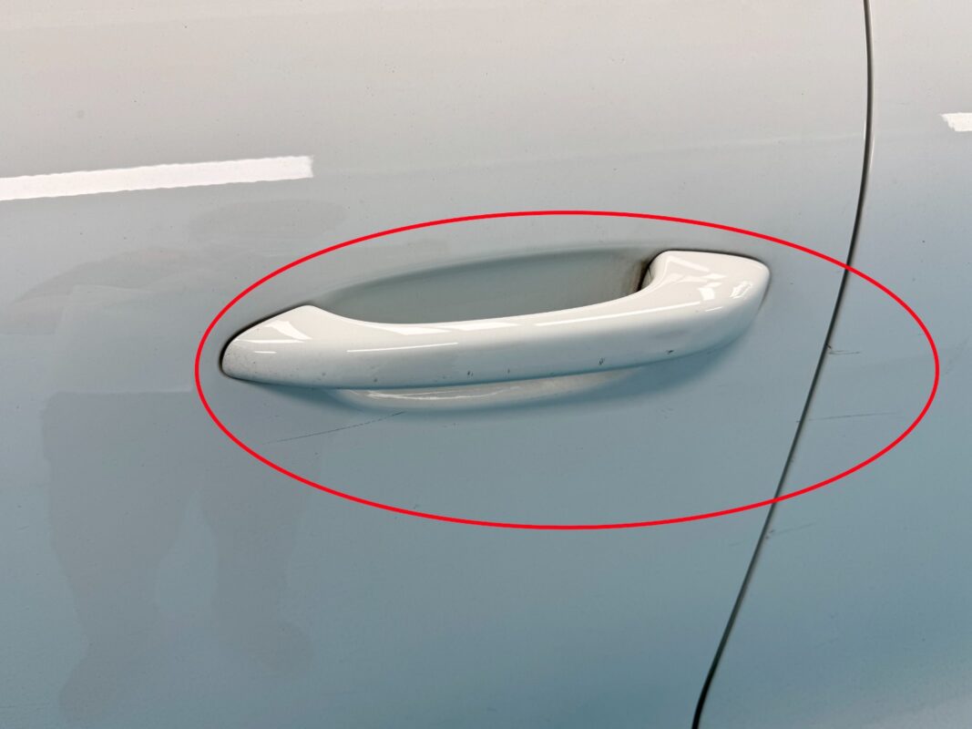 The Porsche Macan from another angle at intake, showing the scratches and stone chips.