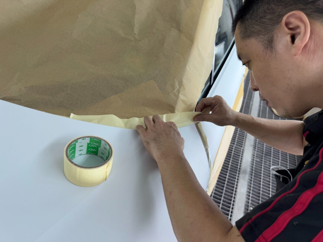 Non-painted surfaces being masked off on the Porsche Macan.