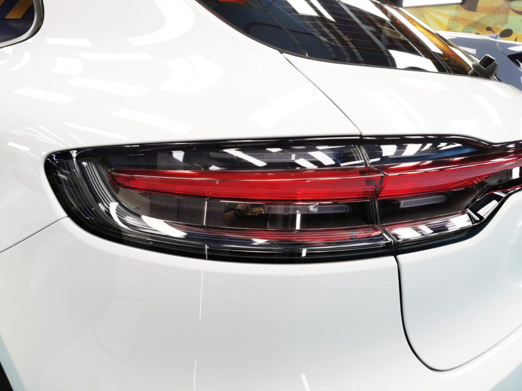 The coated bonnet of the Porsche Macan II under workshop lighting.