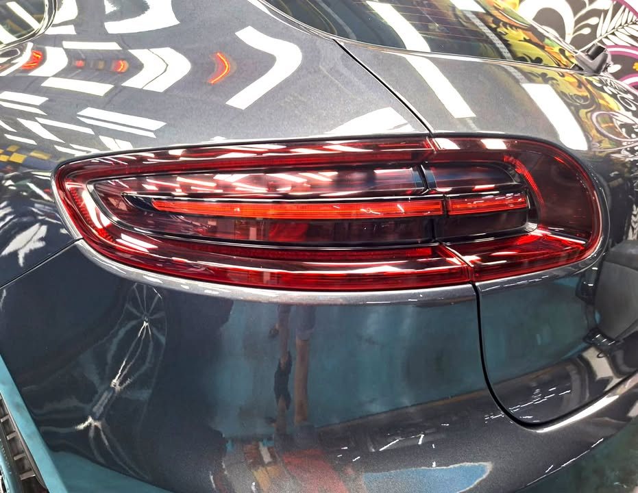Porsche Macan tail light and dark grey rear quarter.
