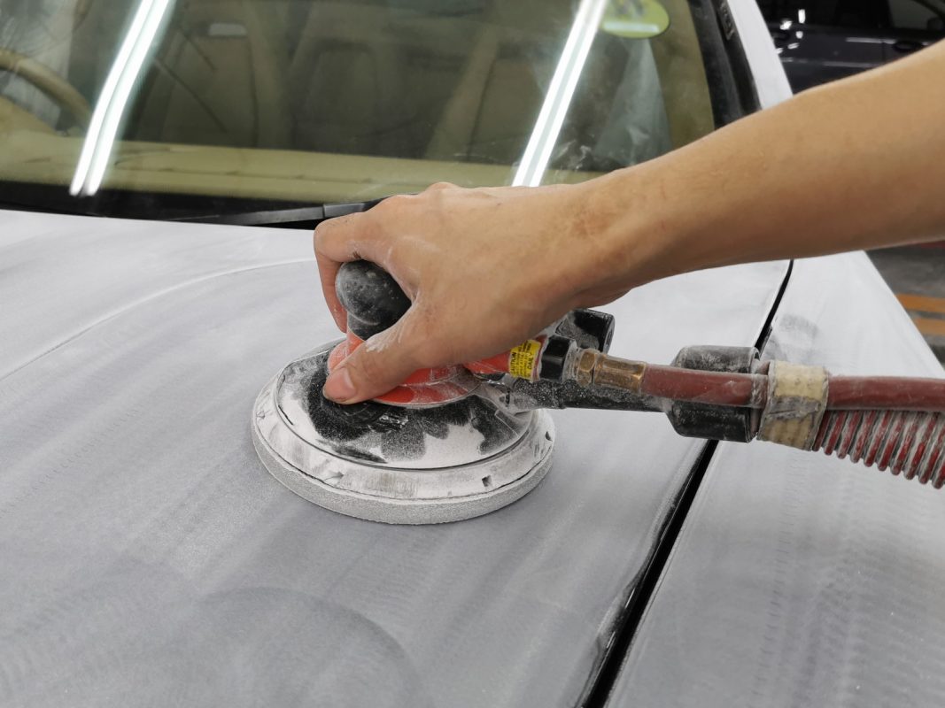 The car's surface inspected and patched where the paintwork was imperfect.