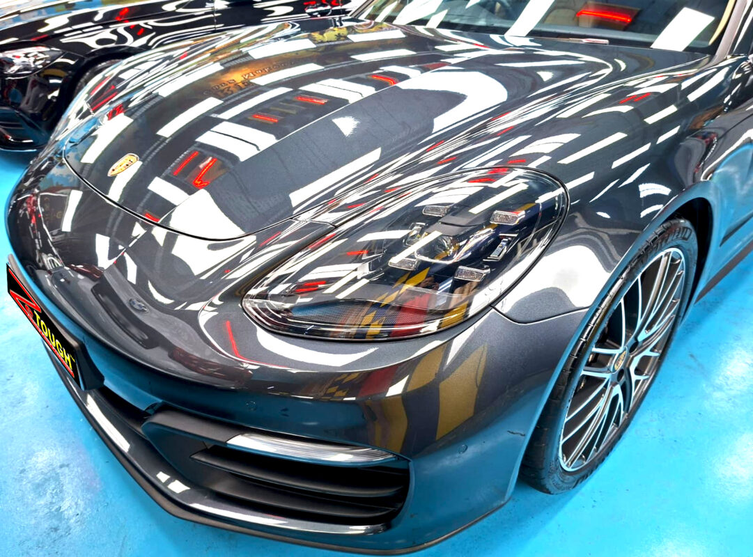 The Porsche Panamera's coated paintwork under workshop lighting.