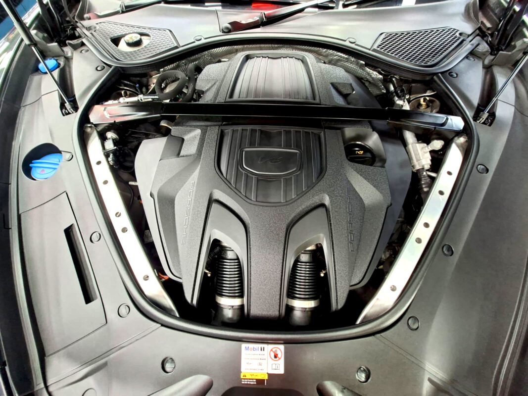 Reflections across the coated panels of the Porsche Panamera.