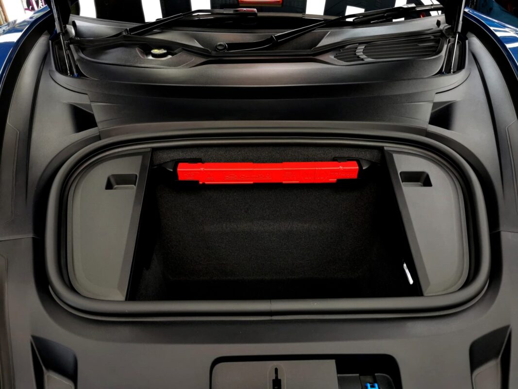 Reflections across the coated panels of the Porsche Taycan.