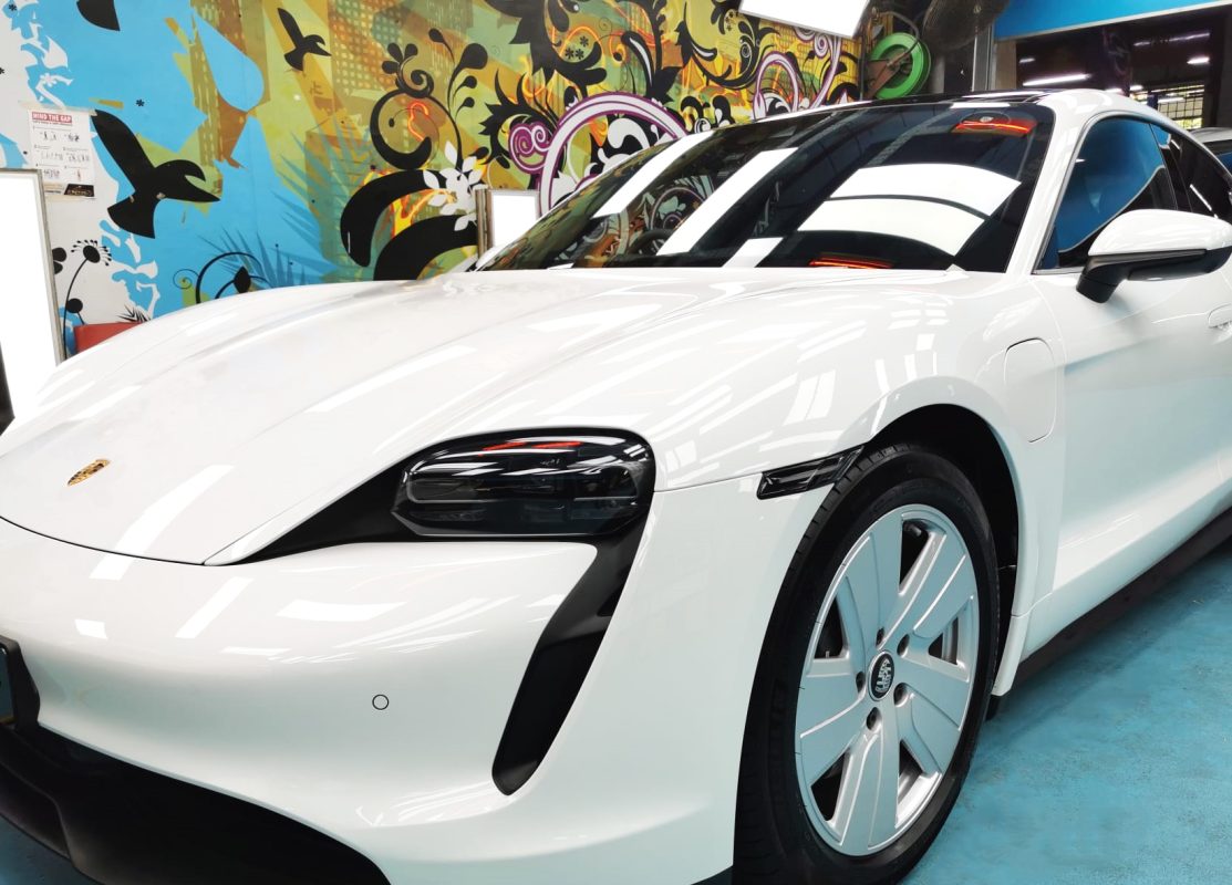 The Porsche Taycan from a side angle after the ceramic coating.