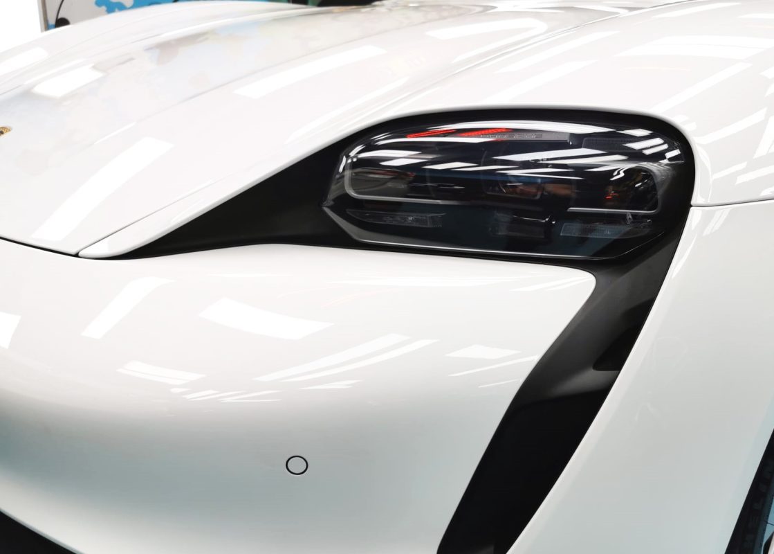 The Taycan's coated paintwork showing clean reflections.