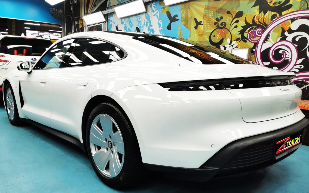 Rear quarter of the Porsche Taycan, glossy and protected.