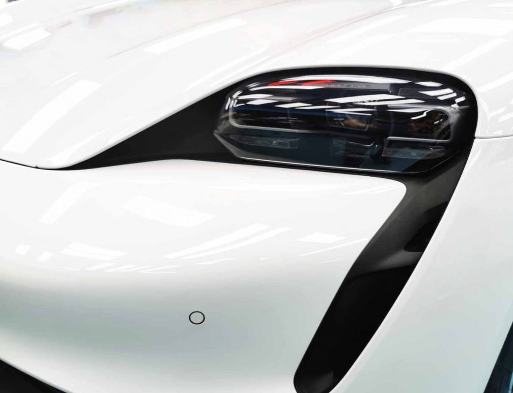 The Taycan's coated paintwork showing clean reflections.