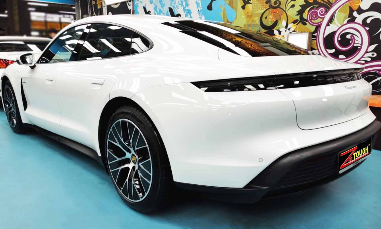 Rear quarter of the Porsche Taycan, glossy and protected.