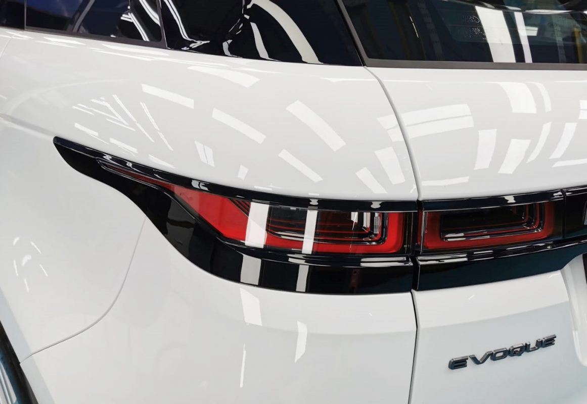 The coated bonnet of the Range Rover Evoque under workshop lighting.