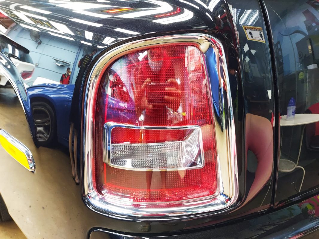 The coated bonnet of the Rolls-Royce Phantom under workshop lighting.