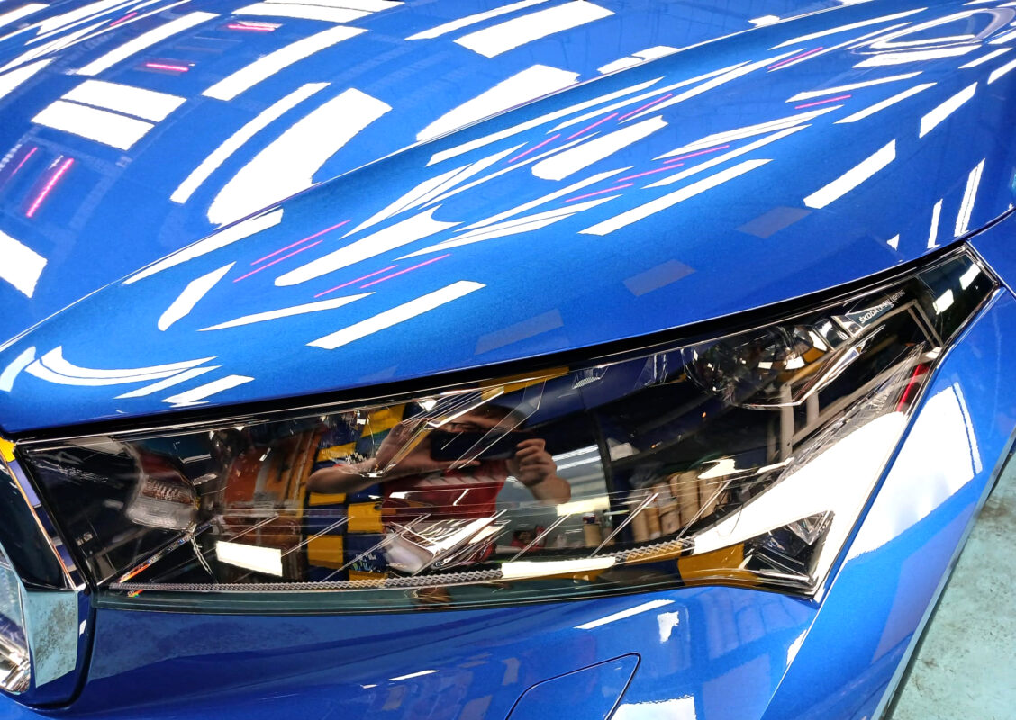 The Enyaq's coated paintwork holding clean reflections.