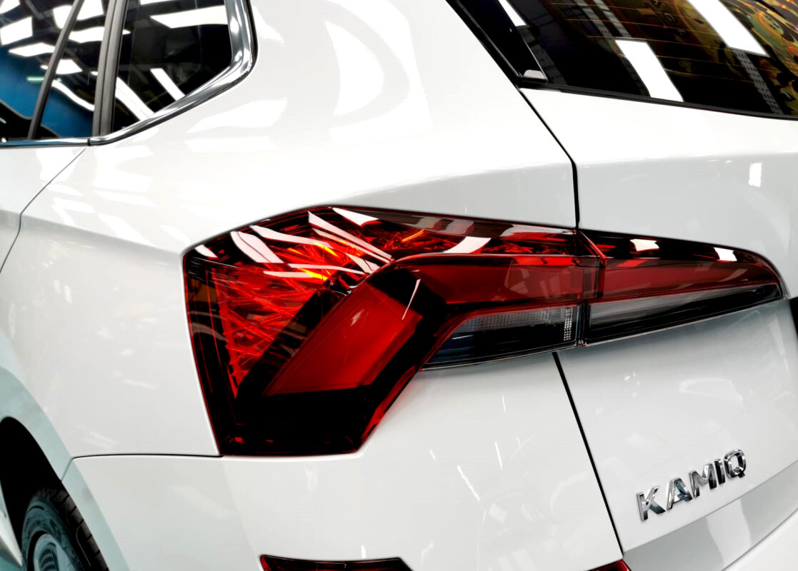 The coated bonnet of the Skoda Kamiq under workshop lighting.