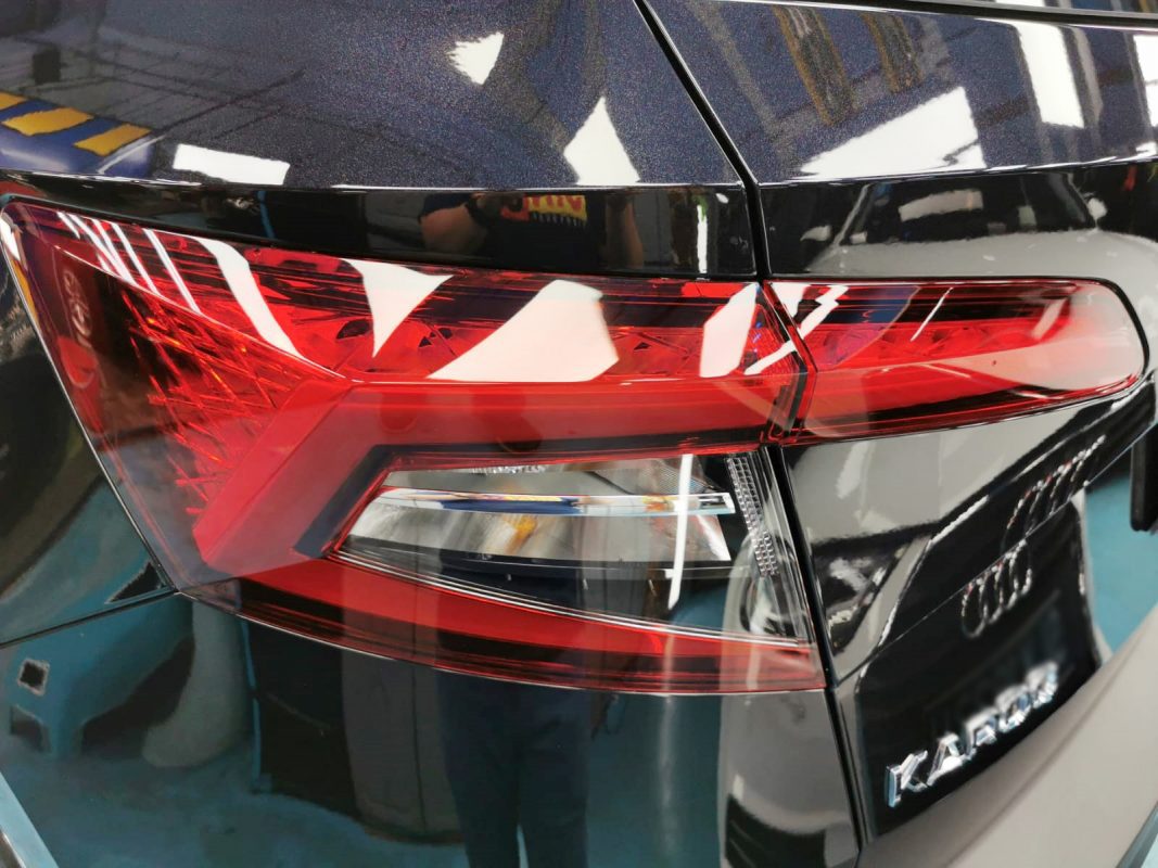 The coated bonnet of the Skoda Karoq under workshop lighting.