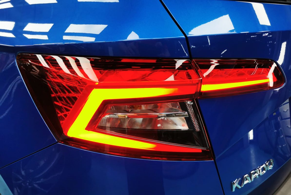 The coated bonnet of the Skoda Karoq under workshop lighting.