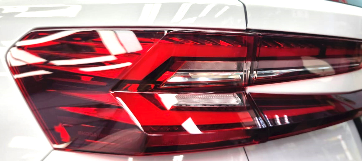 The coated bonnet of the Skoda Kodiaq under workshop lighting.