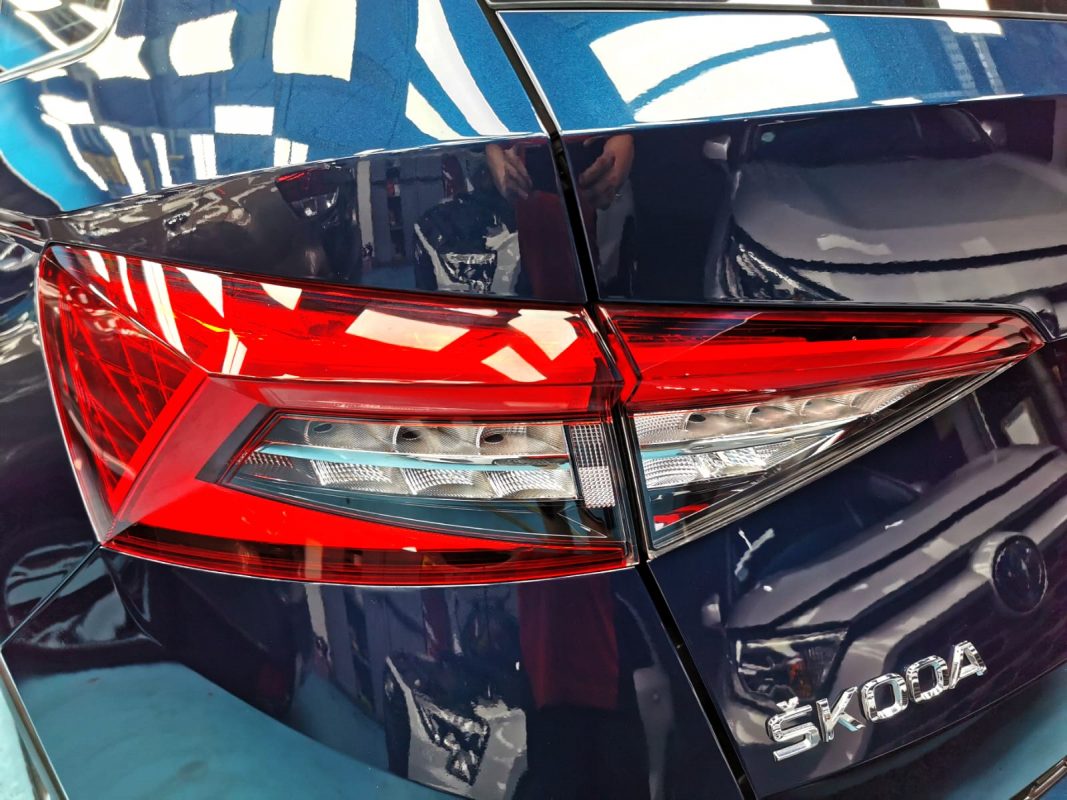 The coated bonnet of the Skoda Kodiaq under workshop lighting.