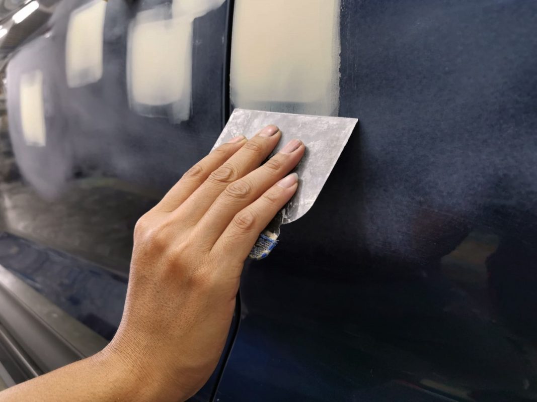 The car's surface inspected and puttied where the paintwork was imperfect.