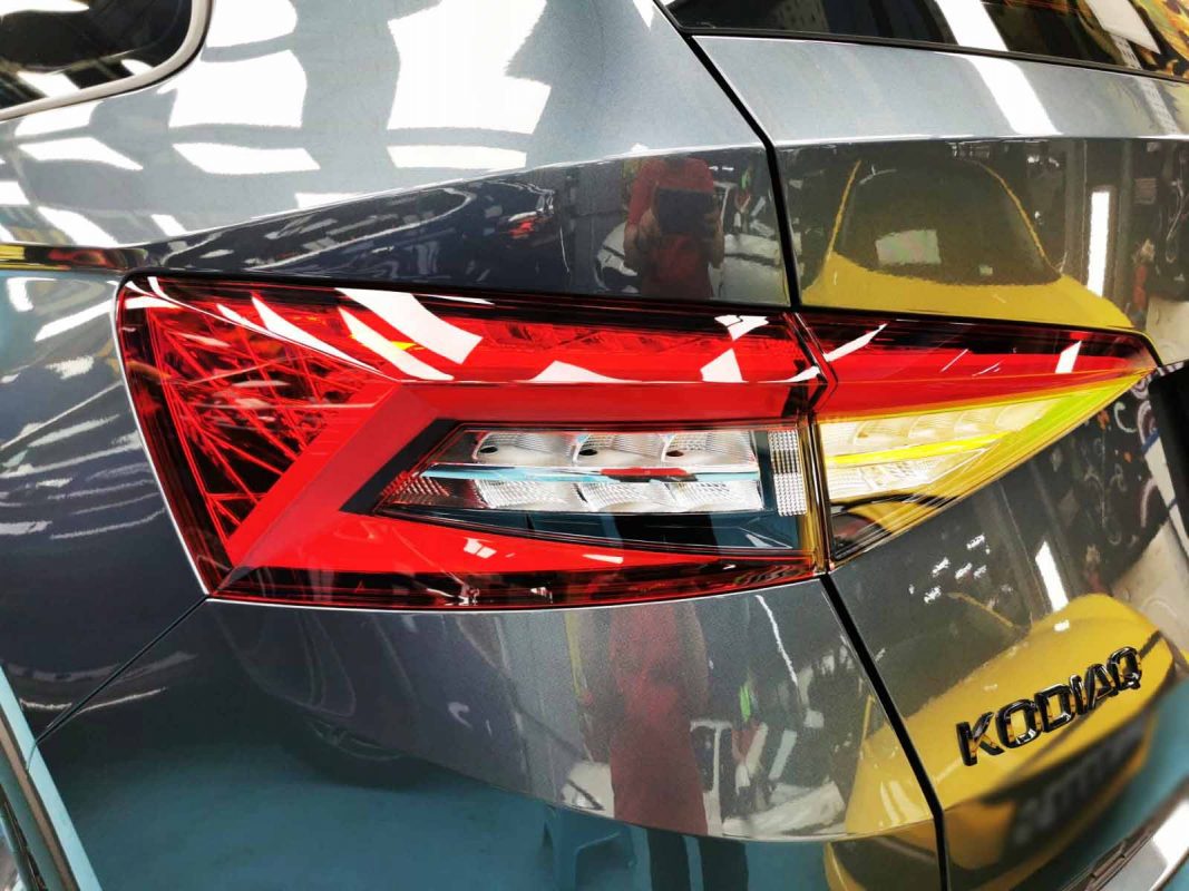 The coated bonnet of the Skoda Kodiaq under workshop lighting.