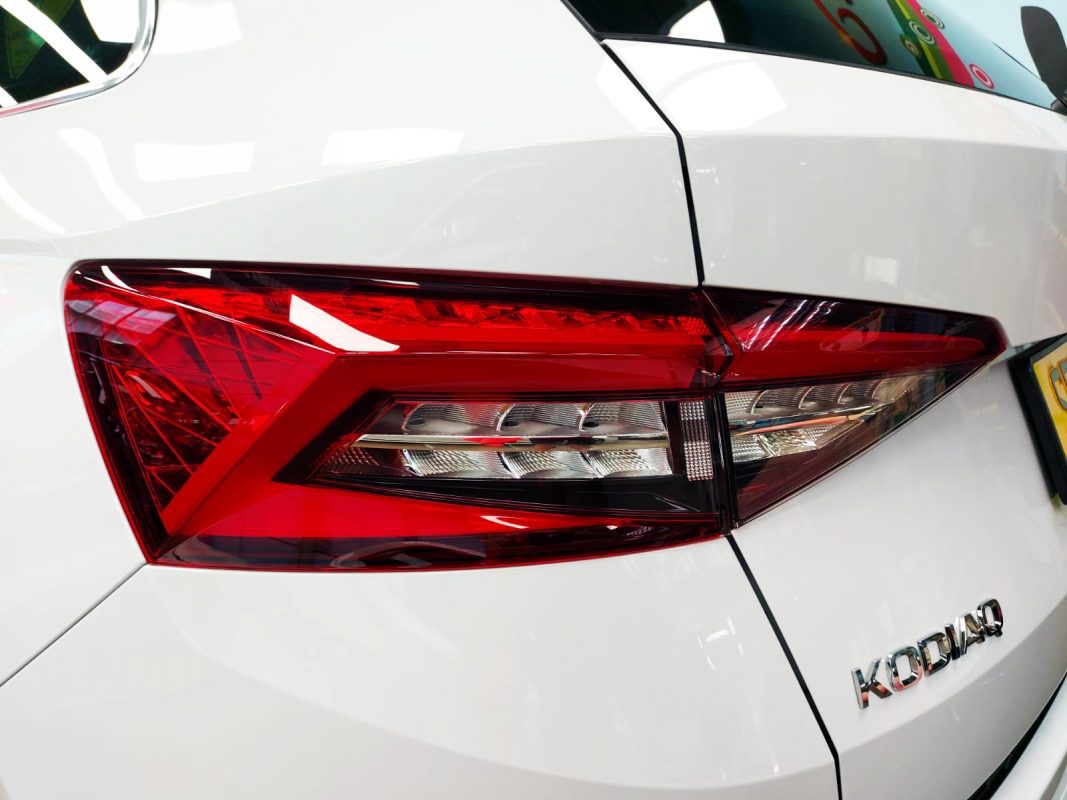 The coated bonnet of the Skoda Kodiaq under workshop lighting.